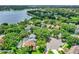 Aerial shot of lakefront homes with pools nestled among lush trees at 991 Hawthorne Cove Ct, Ocoee, FL 34761