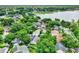 Expansive aerial view highlights lakeside homes surrounded by verdant trees and manicured lawns at 991 Hawthorne Cove Ct, Ocoee, FL 34761