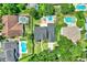 Aerial view of houses, showing the neighborhood layout and swimming pools in backyards at 991 Hawthorne Cove Ct, Ocoee, FL 34761