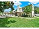 Large backyard with a patio area and furniture, an enclosed sunroom, and lush lawn at 991 Hawthorne Cove Ct, Ocoee, FL 34761