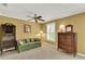 Bedroom featuring a comfortable sofa, a desk, and natural light from shuttered windows at 991 Hawthorne Cove Ct, Ocoee, FL 34761