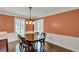 Formal dining room features a wood table, chandelier, and natural light from the window at 991 Hawthorne Cove Ct, Ocoee, FL 34761