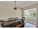 Dining room with wood floors, traditional lighting, and access to the bright sunroom at 991 Hawthorne Cove Ct, Ocoee, FL 34761