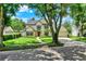Beautiful two-story home with mature shade tree, landscaped yard, and a walkway leading to the front entrance at 991 Hawthorne Cove Ct, Ocoee, FL 34761
