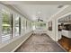 Bright Florida room with brick flooring, ceiling fan, and many windows with plantation shutters at 991 Hawthorne Cove Ct, Ocoee, FL 34761