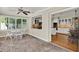 Light filled Florida room leading to the kitchen, features brick floors and a ceiling fan at 991 Hawthorne Cove Ct, Ocoee, FL 34761