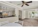 Open floor plan with brick flooring, ceiling fan, and breakfast bar overlooking the kitchen at 991 Hawthorne Cove Ct, Ocoee, FL 34761