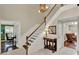 Grand entrance featuring staircase, table decor, and doorways to other living areas at 991 Hawthorne Cove Ct, Ocoee, FL 34761