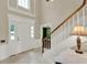 Bright entryway with staircase and tiled floor, leading to other areas of the home at 991 Hawthorne Cove Ct, Ocoee, FL 34761