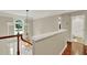 Hallway landing featuring hardwood flooring and an ornate chandelier at 991 Hawthorne Cove Ct, Ocoee, FL 34761