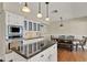 Open kitchen design features black granite countertops, an island, and stainless appliances at 991 Hawthorne Cove Ct, Ocoee, FL 34761