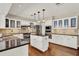 Open kitchen with stainless steel appliances and black granite countertops on the island at 991 Hawthorne Cove Ct, Ocoee, FL 34761