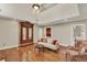Bright living room with tall ceilings has an armoire, wood floors, and neutral colored walls at 991 Hawthorne Cove Ct, Ocoee, FL 34761