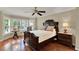 The main bedroom boasts hardwood floors, a ceiling fan, and a bay window with decorative shutters at 991 Hawthorne Cove Ct, Ocoee, FL 34761