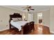 Spacious main bedroom boasts hardwood floors, ceiling fan, and en suite access at 991 Hawthorne Cove Ct, Ocoee, FL 34761