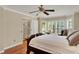Comfortable main bedroom featuring hardwood floors, ceiling fan, bay window, and access to walk-in closet at 991 Hawthorne Cove Ct, Ocoee, FL 34761