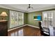 Inviting office featuring hardwood floors, shuttered windows, a television and decorative lighting at 991 Hawthorne Cove Ct, Ocoee, FL 34761