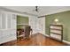 Bright home office with built-in bookshelves, hardwood floors, traditional desk, and decorative lighting at 991 Hawthorne Cove Ct, Ocoee, FL 34761