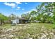 Spacious backyard featuring lush greenery, a screened in porch, and a peaceful outdoor setting at 1000 Sal St, Ocoee, FL 34761