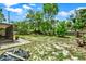 Expansive backyard featuring mature trees, a lawn, and a corner of a screened porch at 1000 Sal St, Ocoee, FL 34761