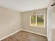 This bedroom has wood-look tile flooring and a window overlooking the backyard at 1000 Sal St, Ocoee, FL 34761
