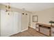 Bright bedroom featuring wood-look tile flooring, white closets, and vintage decor at 1000 Sal St, Ocoee, FL 34761