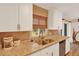 Well-lit kitchen with granite countertops, white cabinets, and stainless steel appliances providing a modern space at 1000 Sal St, Ocoee, FL 34761