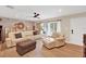 Well-appointed living room featuring modern furniture, a brick accent wall, and bright natural lighting at 1000 Sal St, Ocoee, FL 34761