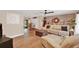 Spacious living room with stylish furniture, a brick accent wall, and an open layout to the dining area at 1000 Sal St, Ocoee, FL 34761