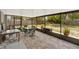Enclosed screen porch featuring brick flooring and a seating area perfect for outdoor relaxation at 1000 Sal St, Ocoee, FL 34761
