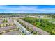 Aerial view of townhomes, green spaces, pond, and nearby highway at 10070 Red Eagle Dr, Orlando, FL 32825