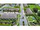 Aerial view of townhome community showcasing streets, green spaces, and entry at 10070 Red Eagle Dr, Orlando, FL 32825