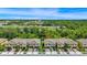Aerial view of a townhome in community with green spaces and roadways at 10070 Red Eagle Dr, Orlando, FL 32825