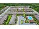 Aerial view of community featuring townhomes, pond, pool, and landscaping at 10070 Red Eagle Dr, Orlando, FL 32825