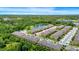 Aerial view of the residences showcases the serene pond and lush green surroundings of the community at 10070 Red Eagle Dr, Orlando, FL 32825