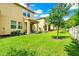Exterior of a house with an inviting patio area, landscaping, and well-maintained lawn at 10070 Red Eagle Dr, Orlando, FL 32825