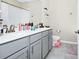Well-lit bathroom boasts double sink vanity, modern fixtures, toilet, and neutral tile flooring at 10070 Red Eagle Dr, Orlando, FL 32825