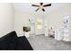 Bedroom with ceiling fan, mirror, shelving, white desk and pink chair at 10070 Red Eagle Dr, Orlando, FL 32825