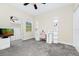 Bedroom with ceiling fan, mirror, shelving, white desk and pink chair at 10070 Red Eagle Dr, Orlando, FL 32825