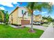 Two-story home with an attached two-car garage, well-maintained lawn, and attractive landscaping elements at 10070 Red Eagle Dr, Orlando, FL 32825