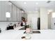 Modern kitchen with gray cabinets, quartz countertops, stainless steel appliances and pendant lighting at 10070 Red Eagle Dr, Orlando, FL 32825