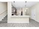 Bright kitchen island with pendant lighting, gray cabinets, stainless appliances, and wood-look tile flooring at 10070 Red Eagle Dr, Orlando, FL 32825
