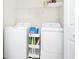 Laundry room with washer, dryer, shelving, and cleaning supplies at 10070 Red Eagle Dr, Orlando, FL 32825