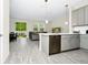 Open-concept kitchen and living room featuring modern stainless steel appliances, island, and natural lighting at 10070 Red Eagle Dr, Orlando, FL 32825