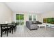 Bright living room with tile floors, comfortable seating, and natural light from the sliding glass doors to the patio at 10070 Red Eagle Dr, Orlando, FL 32825