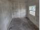 Empty bedroom with unfinished walls and concrete floors, waiting for your personal touch at 1020 E Main St, Haines City, FL 33844
