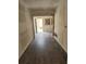 A hallway featuring wood-look flooring leading to a doorway and view of the outdoors at 1020 E Main St, Haines City, FL 33844