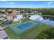 Aerial view of tennis courts, pool, pond, clubhouse, and playground at community center at 1434 Pacific Rd, Kissimmee, FL 34759