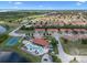 Aerial view of community featuring pool, clubhouse, tennis courts, and beautiful landscaping at 1434 Pacific Rd, Kissimmee, FL 34759