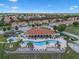 Aerial view of community featuring pool, tennis courts, playground, and beautiful landscaping at 1434 Pacific Rd, Kissimmee, FL 34759